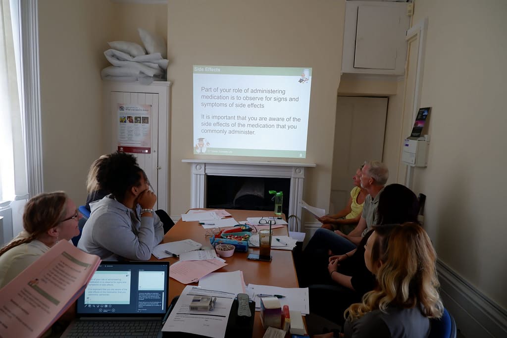 Aurora Community Care Givers being trained on Medication Administration.