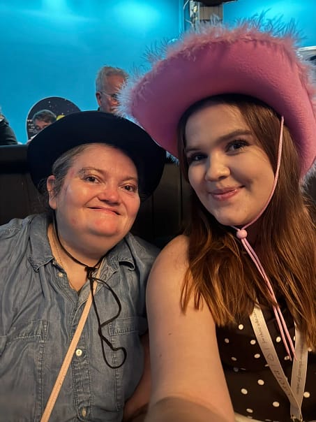 An Aurora Care Giver and client enjoying a country music show together.