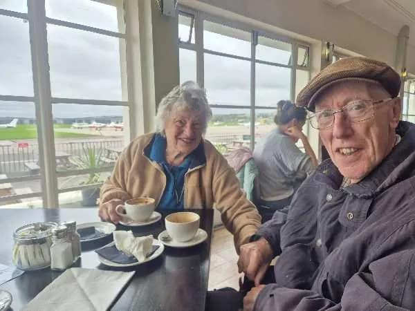 Aurora Community Care clients enjoying coffee together by the seafront